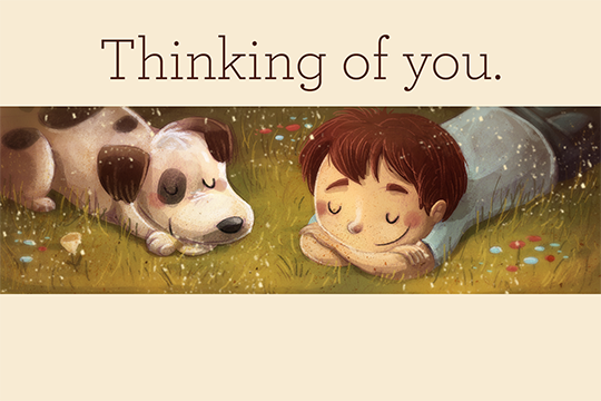 Beige "Thinking of you" card with illustrated boy and dog laying in grass
